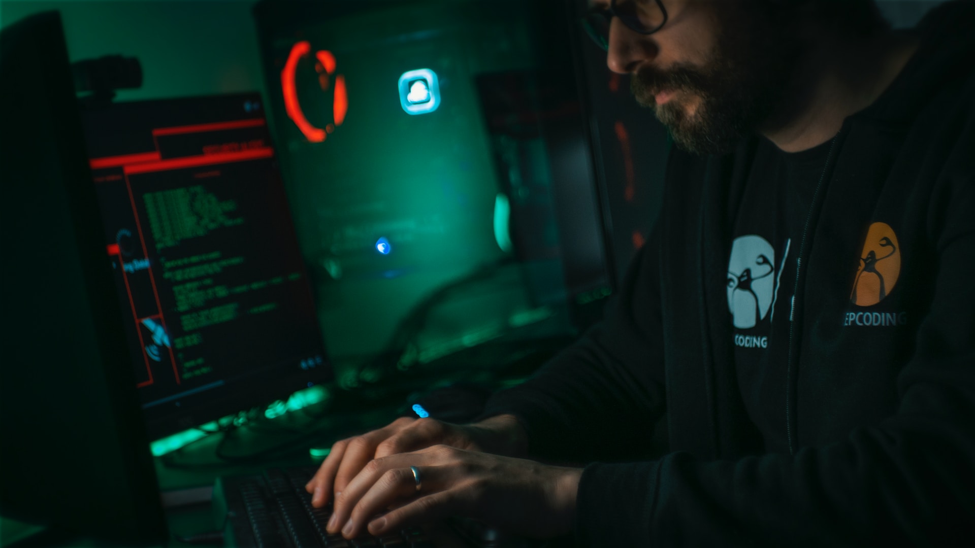 A man coding on a laptop